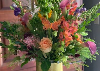 floral bouquet with bright colors in cylinder vase