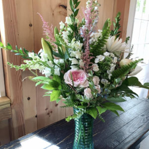 pink and white flowers with greenery in vase