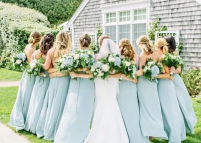 bridal party hugging with bouquets