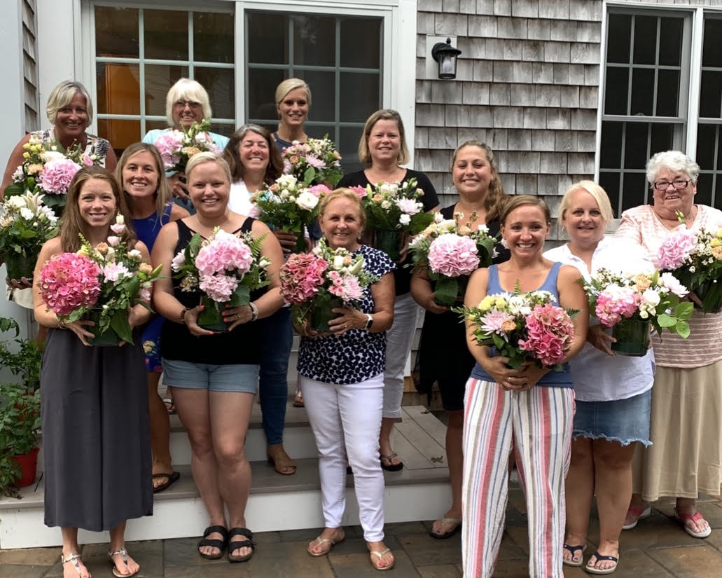 group of people after flower arrangement class